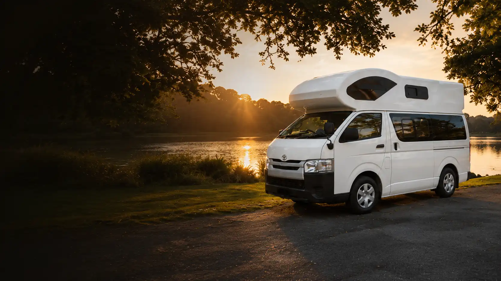 Elite RV Enigma four-berth Toyota Hiace campervan beside a lake